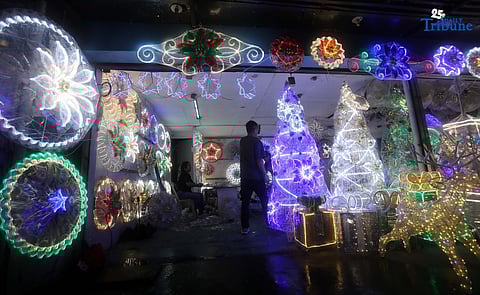 Passersby take photos of a dazzling Christmas lantern for sale at Brgy. North Fairview along Commonwealth Avenue in Quezon City on Sunday night, September 14, 2025. The Philippines celebrates the world’s longest Christmas season, which begins during the “ber” months, with the 100-day countdown to Christmas starting on September 16, 2025.