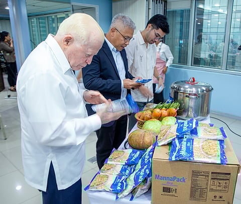 ASA Philippines Chairman of the Board Amb. Jose L. Cuisia Jr., President and CEO Mr. Rafael C. Lopa, and DepEd Director IV Dr. Miguel Angelo S. Mantaring inspect the MannaPack Rice during the launch of the Sustansya at Pag-ASA Child Nutrition Program