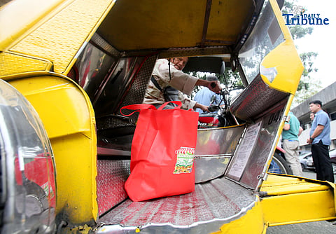 A tricycle driver, a member of a transport group, rides away after buying 10 kilos of rice at P20 per kilo during the rollout of the “Benteng Bigas, Meron Na!” Rice Project for the transport sector. The distribution was held at the Kadiwa ng Pangulo Center in BAI, Quezon City on Tuesday.