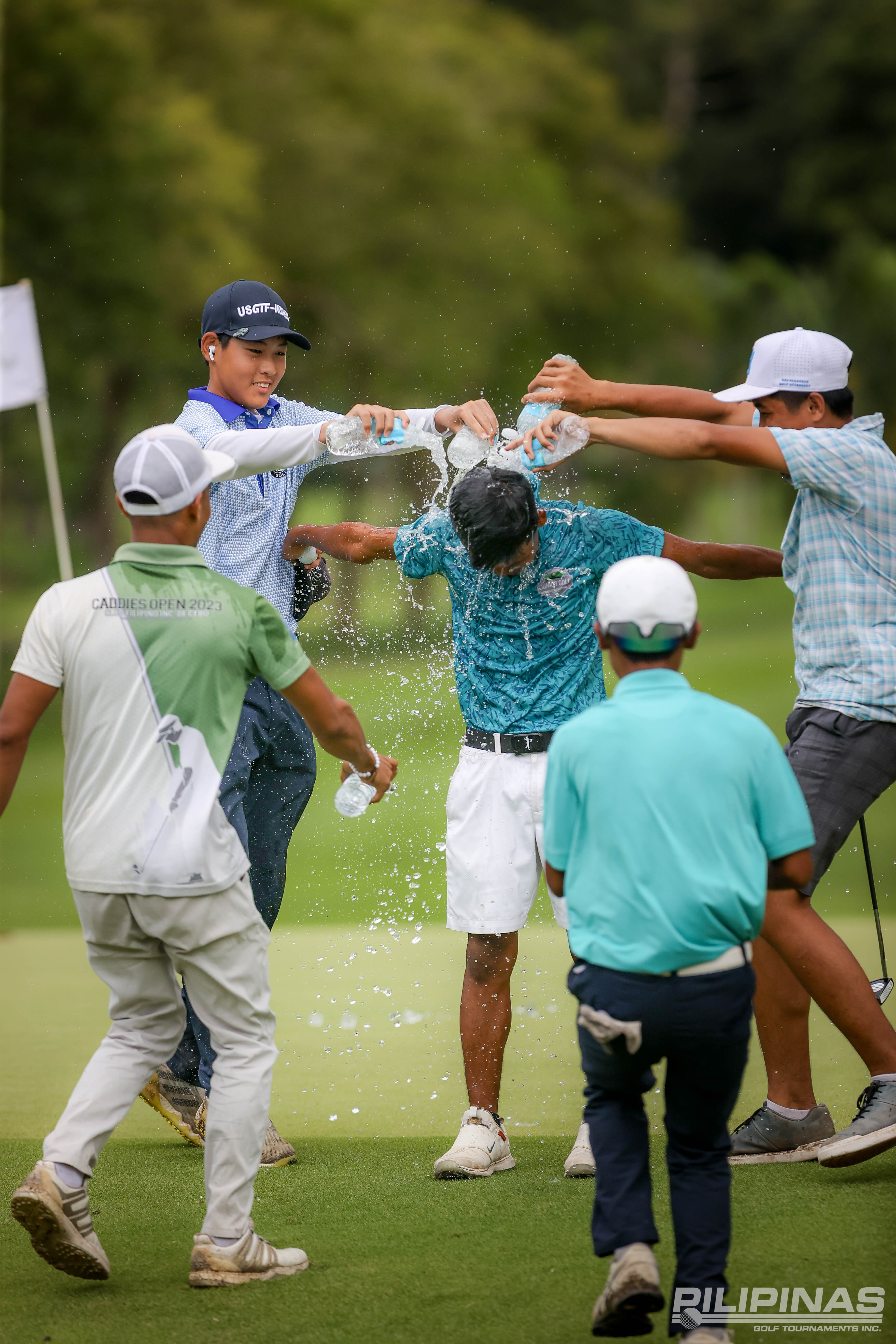 JOHN Paul Oro is doused with water by fellow competitors after winning the ICTSI Negros Occidental Junior PGT Championship at Marapara course.