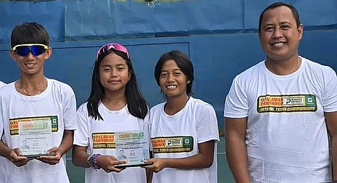KREZL Gecosala (left) holds his trophy as he shares the podium with co-Most Valuable Player titles with Arissa Macapendeg and Ayl Gonzaga. Also shown is Deputy Mayor for Christian Settlers Art Calingasan (right).