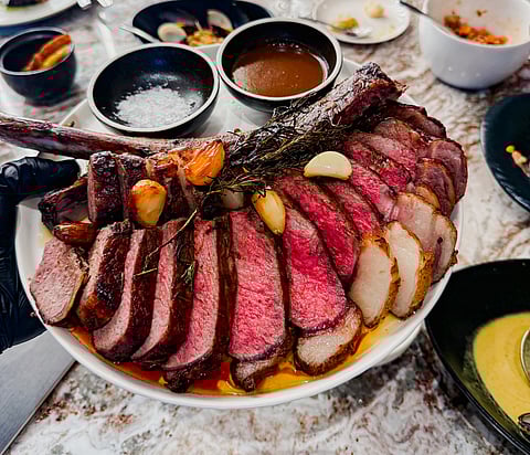 The pièce de rèsistance: bone-in ribeye Australian Okan Tomahawk wagyu steak, red wine sauce, Maldon salt.