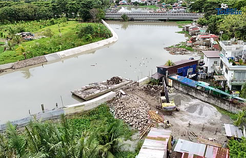 Workers continue concrete laying on the DPWH Bulacan 1st District’s riverbank protection project amid high tide along the river in Barangay Santa Cruz, Guiguinto, Bulacan on Friday, 19 September 2025. The project is implemented by M3 Konstract Corporation. 