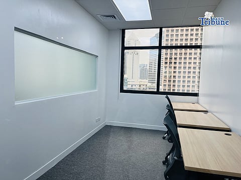 A bright window view highlights a small office room.