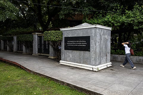 Students walk past the Victims of Martial Law Memorial Wall in Manila on Saturday, 20 September 2025, a day before the late dictator Ferdinand Marcos Sr. signed Proclamation No. 1081, marking the beginning of a fourteen-year period of Martial Law.