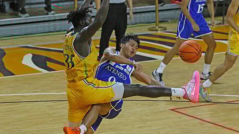 JARED Bahay of Ateneo braves the defense of Mo Konateh of FEU to make a drop pass to teammate Kymani Ladi during the crucial stretch of their UAAP Season 88 men’s basketball tournament game yesterday at the UST Quadricentennial Pavilion. The Blue Eagles prevailed in overtime, 86-83.