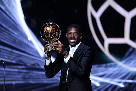 
OUSMANE Dembele celebrates after securing the Ballon d’Or trophy for leading Paris Saint-Germain to the Champions League title.