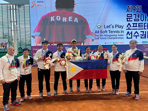 
BIEN Zoleta, Princess Catindig, Joseph Arcilla and Samuel Nuguit celebrate with their coaches after winning the gold medal in the 9th Asian Soft Tennis Championship in South Korea.