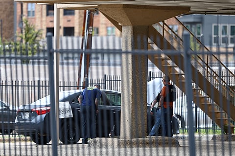 Law enforcement, including members of the FBI, investigate a vehicle parked near the building alledgely used by the shooter, following a shooting near a US Immigration and Customs Enforcement (ICE) detention facility in Dallas, Texas, on September 24, 2025. Two detainees were shot dead and one wounded in Wednesday's sniper attack at a US immigration facility in Dallas, the Department of Homeland Security said. The shooter fired "indiscriminately" from a nearby rooftop at the US Immigration and Customs Enforcement (ICE) building before taking his own life, DHS said in a statement.
