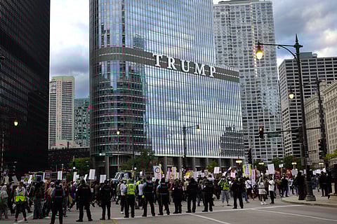 Demonstrators march past Trump Tower during a protest against President Donald Trump's immigration policies on September 06, 2025 in Chicago, Illinois. The Trump administration has threatened a surge in ICE raids in the Chicago area that was expected to begin today. Scott Olson/Getty Images/AFP