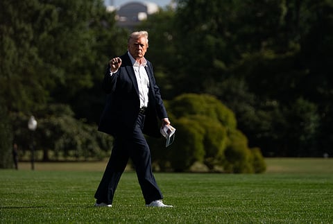 US President Donald Trump walks to the Oval Office of the White House upon return from attending the Ryder Cup golfing tournament in Farmidale, New York, in Washington, DC, on September 26, 2025.