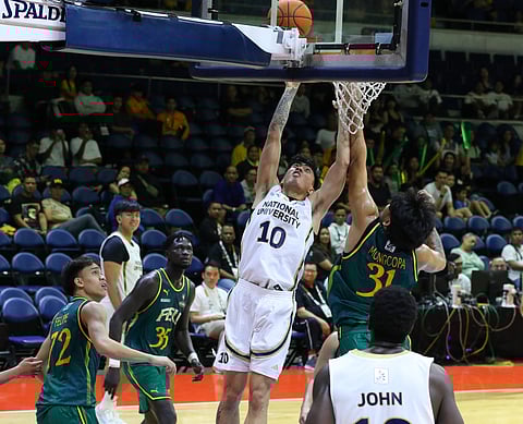 
Jolo Manansala delivers the telling blows in NU’s 84-68 win over FEU in their Season 88 UAAP men’s basketball tournament game on Saturday at the Smart Araneta Coliseum.
