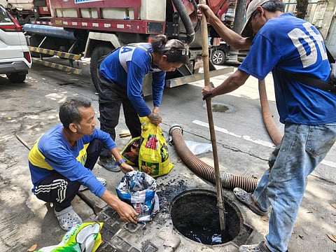 Workers from Manila's Department of Engineering and Public Works conduct declogging operations along Abad Santos Avenue as part of Mayor Isko Moreno's order to clean the city streets.