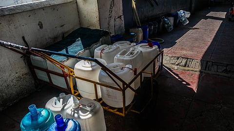 RESIDENTS of Tenement use push carts to carry gallons of water as water isn't accessible.