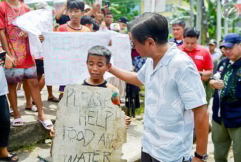 On the ground Ensuring that assistance is duly provided to the people affected by the recent 6.9-magnitude quake in Cebu, President Ferdinand R. Marcos Jr. visits towns and interacts with residents who have lost homes, loved ones and access to food and water, assuring them of quick response. (Left) People queue up with their plastic containers for water rations in Bogo City, Cebu province on 2 October.