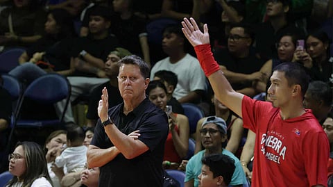 Magnolia playing-coach LA Tenorio (right) pursues the job of outperforming his former coach Tim Cone of Barangay Ginebra in their Philippine Cup game Sunday at the Smart Araneta Coliseum.