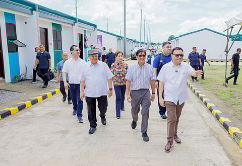 President Ferdinand R. Marcos Jr., (center) along with DHSUD Secretary Jose Ramon Aliling (right) walks around  in St. Barts Southville Heights in Barangay San Bartolome, San Pablo City, Laguna to personally inspect the project prior to the inauguration and awarding of the  new house and lot units to beneficiaries.