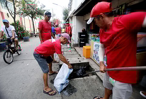 Workers from the Metropolitan Manila Development Authority and residents of Barangay Tangos in Navotas City work hand in hand to clean the surroundings which is part of the MMDA’s ‘Bayanihan sa Barangay’ program.