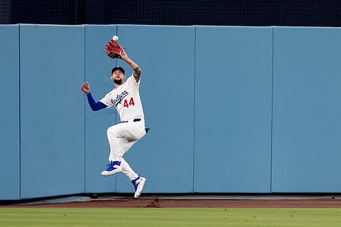 ANDY Pages catches a fly ball that helped the Los Angeles Dodgers post a 2-1 walkoff win over the Philadelphia Phillies in the playoffs of Major League Baseball.