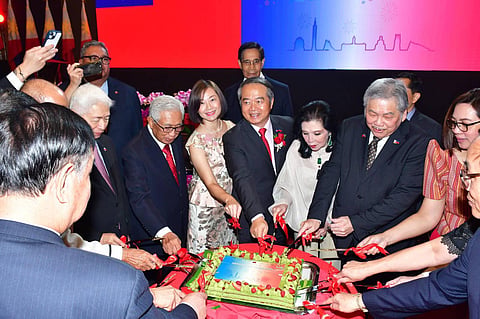 
Taiwanese envoy Wallace Chow (center) cuts the National Day cake in Manila, a small, sweet ritual beneath a watchful world.

