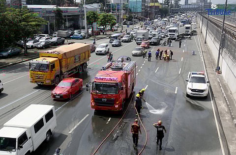 (October 11 2025) To avoid an accident  Bureau of Fire Protection BFP personnel used water cannons to remove the oil spilled from the truck scattered along Commonwealth Avenue in Quezon City on Saturday October 11 2025, and it caused a heavy traffic.  Photo/Analy Labor