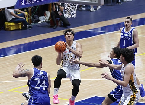 
Nic Cabanero delivers the telling blows in UST’s triple overtime 98-89 win over Ateneo on Saturday in their UAAP Season 88 men’s basketball tournament game at the Blue Eagle Gym.