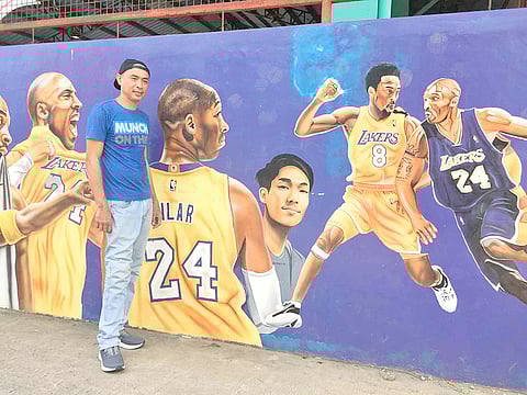 Batain with his mural in Malvar.