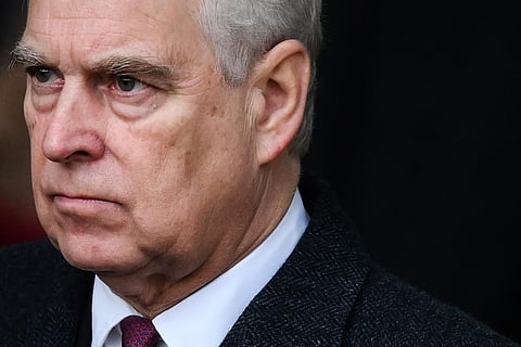 (FILES) Britain's Prince Andrew, Duke of York reacts as he leaves at the end of the Royal Family's traditional Christmas Day service at St Mary Magdalene Church in Sandringham, Norfolk, eastern England, on December 25, 2022. UK's scandal-hit Prince Andrew said on October 17, 2025, he is giving up his royal title.