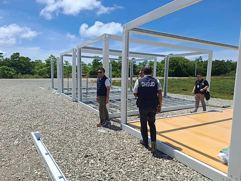 DEPARTMENT of Human Settlements and Urban Development Secretary Jose Ramon Aliling (left), alongside DHSUD officials, conducts an inspection of the construction site of the second Bayanihan Village in Barangay Pajo in the town of Daanbantayan, Cebu. 