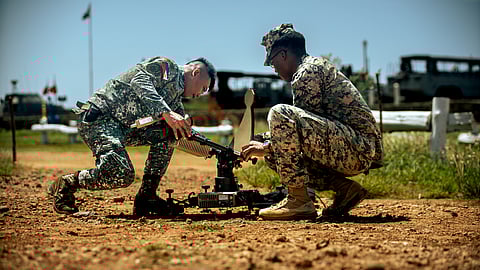 (LEFT TO RIGHT) Philippine Marine Corps Staff Sgt. Lhardnernomer Sales, the communications noncommissioned officer in charge of 4th Marine Brigade, and U.S. Marine Corps Cpl. Donya Grady, a satellite transmissions operator assigned to Marine Rotational Force-Southeast Asia, I Marine Expeditionary Unit, set up a Viasat Multi-Mission Terminal during a staff exercise at Marine Base Camp Cape Bojeador, Philippines, 7 October 2025. The MMT provides secure, high-bandwidth satellite communications for real-time data in austere environments. 
