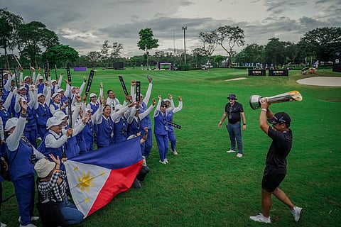 
MIGUEL Tabuena presents the trophy to the caddies after winning the International Series Philippines presented by BingoPlus on Sunday at the Sta. Elena Golf and Country Club.