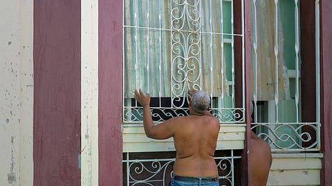 Hurricane preparedness A resident secures his home with sheets of corrugated iron as Hurricane ‘Melissa’ approaches Santiago de Cuba on Tuesday — a monstrous Category 5 storm forcing thousands to flee or take cover.
