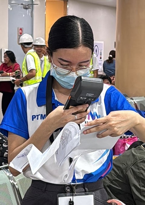 A personnel of UCC Tech gets the information of a passenger at the North Port terminal in Manila.
