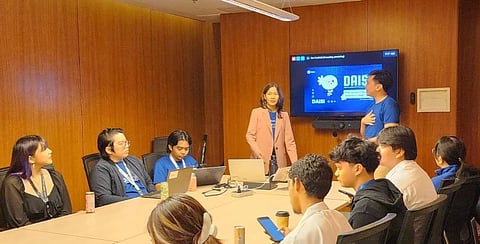 Process and Automation Engineers for Service Operations Jennifer Dela Cruz (standing, left) and Seth Munar introduce DAISI to DevCon 2025 participants. 