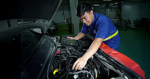 
A TOYOTA technician checks a car’s engine as part of the brand’s free roadside assistance offered for Undas travelers.