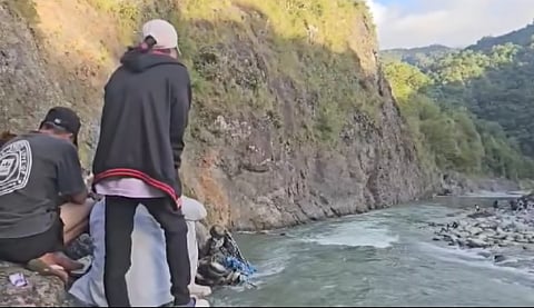 A grab from the video where Nida Romeo was calling for the spirit of his nephew who is one of the victims of the October 27, tragedy where their truck fell into a 150-170 feet ravine in Barangay Tocucan, Bontoc, Mountain Province. She was encouraged by the community women and elders to do the traditional "Ayag si Leng-ag" to call for her nephew to help the search teams find him, and after more than 40 minutes, he was as finally found. |Aldwin Quitasol.