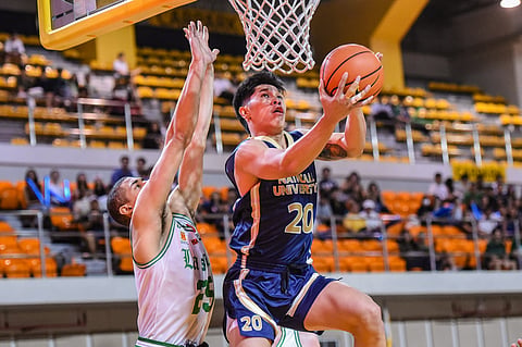 
Jake Figueroa of NU and Mike Phillips of La Salle try to tow their respective team into victory in an explosive rematch in the UAAP Season 88 men’s basketball tournament.