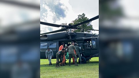 Personnel from the Philippine Air Force and Philippine Army load the six retrieved remains from the Super Huey helicopter that crashed in Agusan del Sur on 4 November 2025 onto a Black Hawk helicopter.