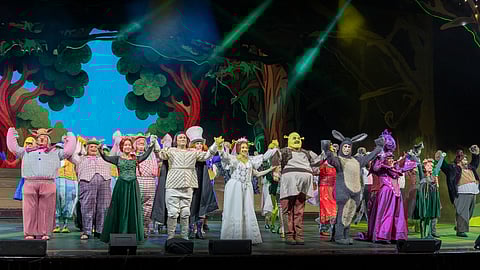 The cast of Shrek The Musical takes center stage for the curtain call.