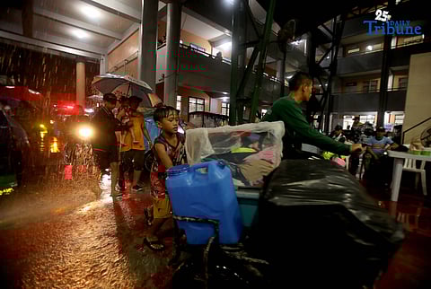 Residents living near the Marikina River arrive at H. Bautista Elementary School in Marikina City after evacuating their homes on 9 November 2025, as a preemptive measure ordered by the local government ahead of Super Typhoon Uwan.