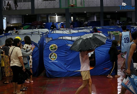 Residents living near the Marikina River arrive at H. Bautista Elementary School in Marikina City after evacuating their homes on 9 November 2025, as a preemptive measure ordered by the local government ahead of Super Typhoon Uwan.