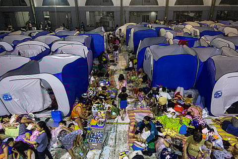 Around 400 families from Manila’s Districts 1 and 3 take shelter at the Delpan Evacuation Center on Monday, November 10, 2025, as Super Typhoon Uwan continues to batter the metro. With the center at full capacity, many evacuees are left resting on chairs and the floor while waiting for conditions to improve.