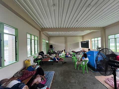 Residents in Barangay Funda-Dalipe, San Jose de Buenavista, Antique, take shelter inside a classroom at Salazar Elementary School, which has been converted into an evacuation center.