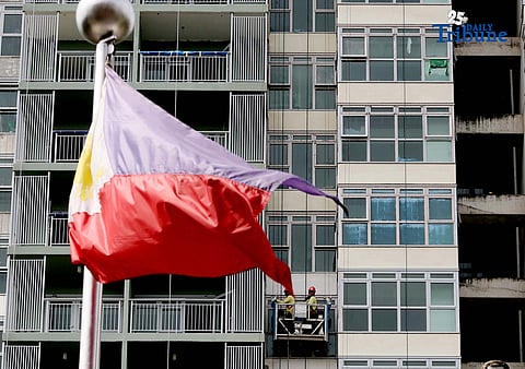 Workers were seen hanging banners and cleaning at a building in Quezon City on Friday, 14 November 2025.

The Philippine peso fell to a new record low of P59.17 to the dollar on Wednesday, pressured by strong demand for the greenback and declining market confidence due to corruption concerns. The currency, whose previous all-time low of P59.13 to the dollar was hit late last month, closed weaker by 18.5 centavos.