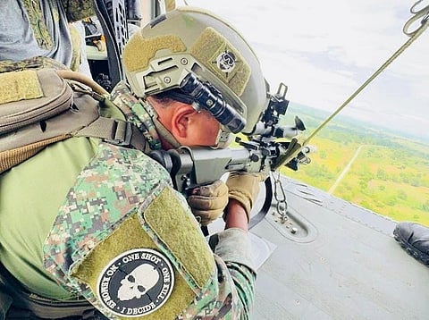 Philippine Army personnel engage in heli-sniping, providing aerial fire support during the airfield seizure exercise.