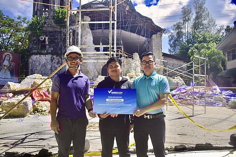 
DAO QUY PHI, managing director of Green GSM Southeast Asia, handed over their donation at the damaged Santa Rosa de Lima church in Daanbantayan.