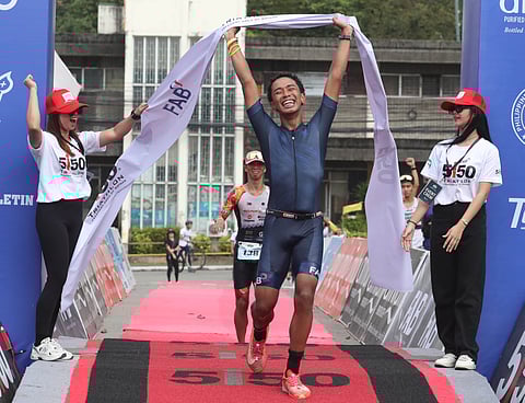 
ERIK Esperanzate celebrates as he crosses the finish line to rule the men’s division of the 5150 FAB Triathlon at the Freeport Area of Bataan on Sunday.     

