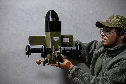 A MEMBER of the 3rd Army Corps Interception Squadron holds an interceptor drone used to protect against Russian drone attacks, at an undisclosed location near the front lines of eastern Ukraine, on 8 October 2025.