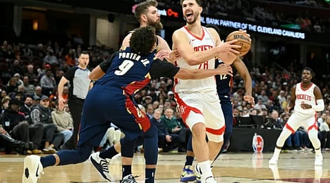 Houston's Alperen Sengun, center right, steps to the basket against Cleveland's Craig Porter Jr., center front, and Dean Wade in a Rockets' NBA victory over the Cavaliers 