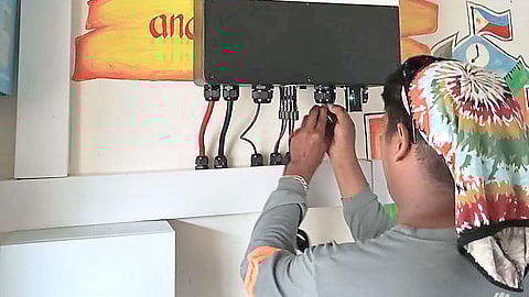 
A TECHNICIAN of Infinite Solar Philippines installs a solar energy inverter and storage system at the Baliwet Elementary School in Barangay Sta. Fe, San Marcelino, Zambales. 